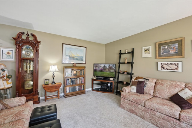 carpeted living area with baseboards