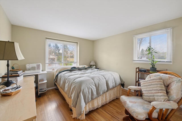 bedroom with baseboards and light wood-style flooring