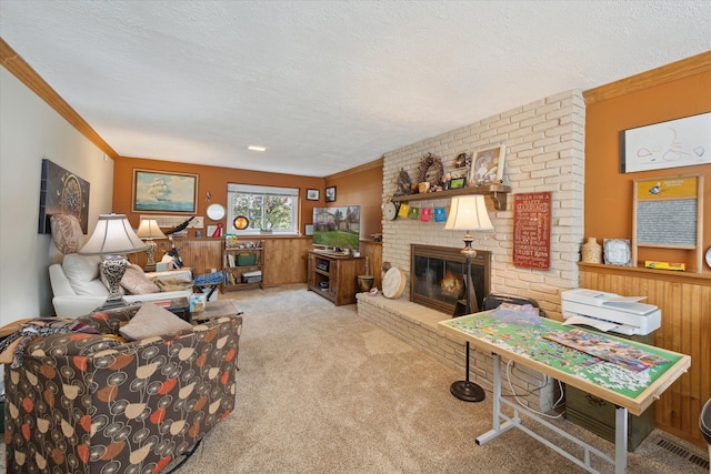 living room featuring carpet flooring, a textured ceiling, crown molding, and a fireplace