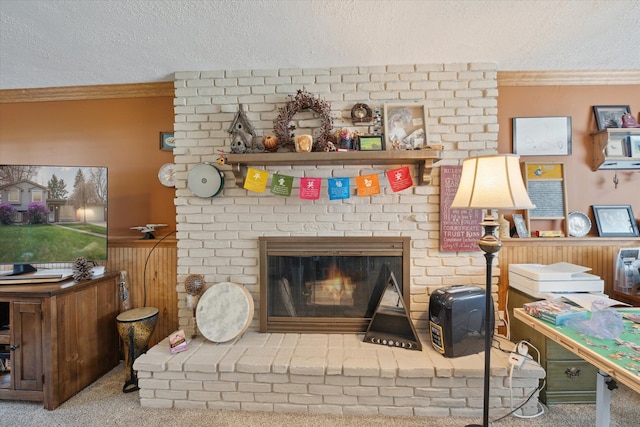 interior space featuring crown molding, wainscoting, a brick fireplace, a textured ceiling, and wood walls