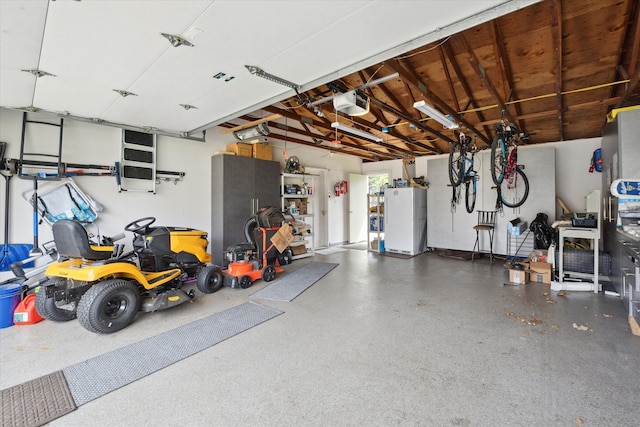 garage featuring a garage door opener and freestanding refrigerator