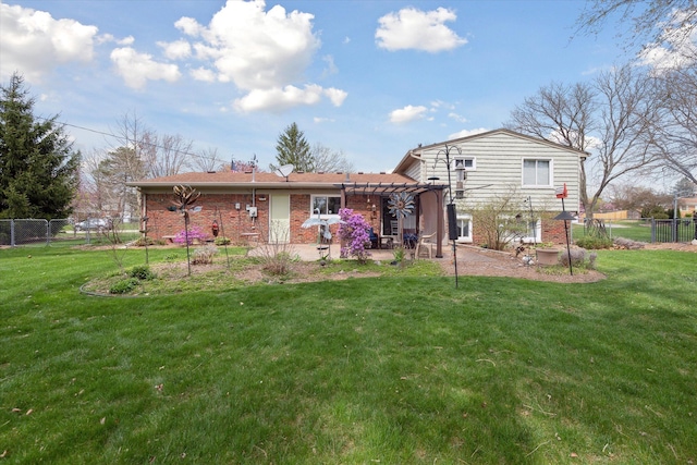 back of house with fence, a pergola, brick siding, a patio area, and a lawn