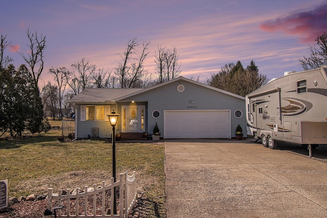 ranch-style home featuring driveway, fence, a lawn, and a garage