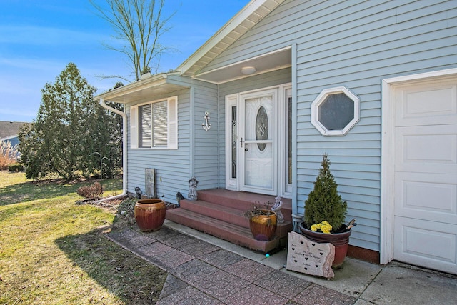 doorway to property featuring a lawn
