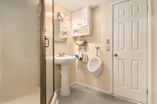 full bathroom with baseboards and a shower stall