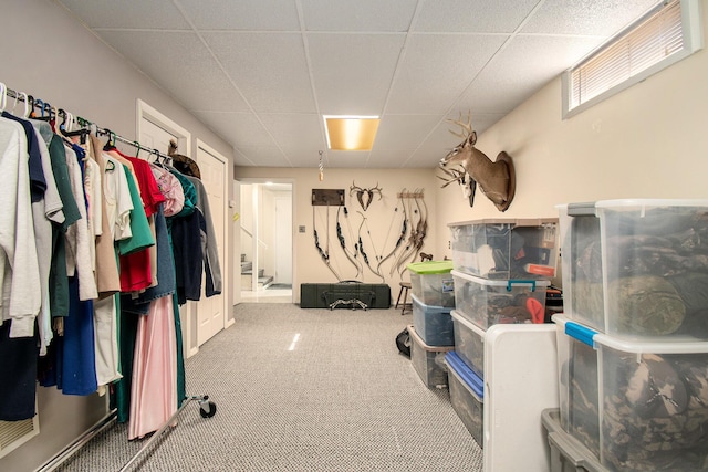 interior space with a paneled ceiling and carpet flooring