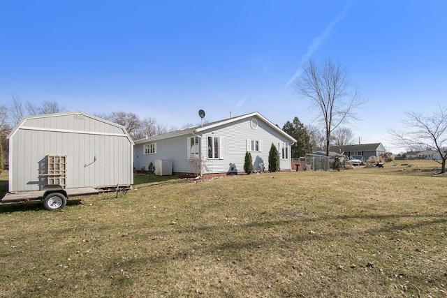 view of home's exterior featuring an outdoor structure and a lawn