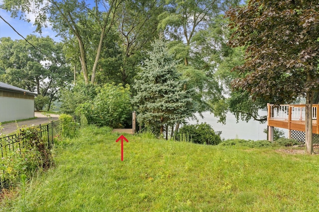 view of yard featuring a deck and fence