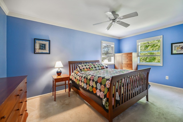 carpeted bedroom with baseboards, ornamental molding, and a ceiling fan