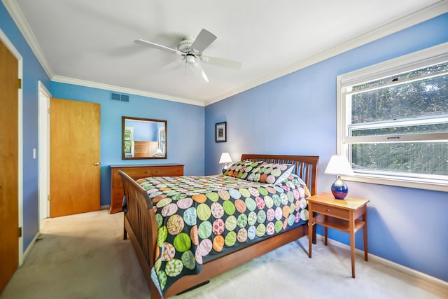 carpeted bedroom featuring ornamental molding, a ceiling fan, visible vents, and baseboards