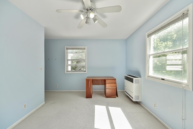 unfurnished bedroom with heating unit, ceiling fan, carpet floors, and baseboards