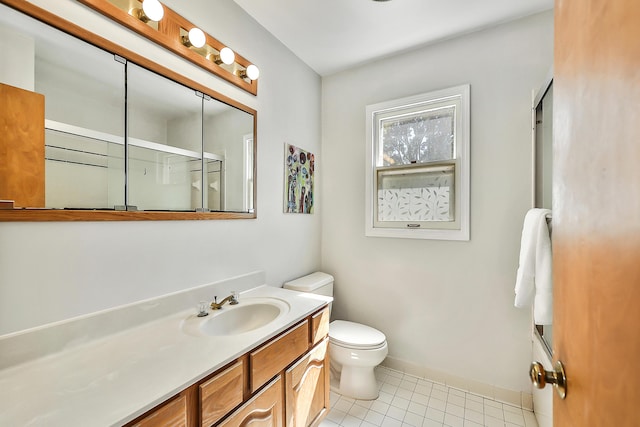 full bath featuring tile patterned floors, an enclosed shower, toilet, vanity, and baseboards