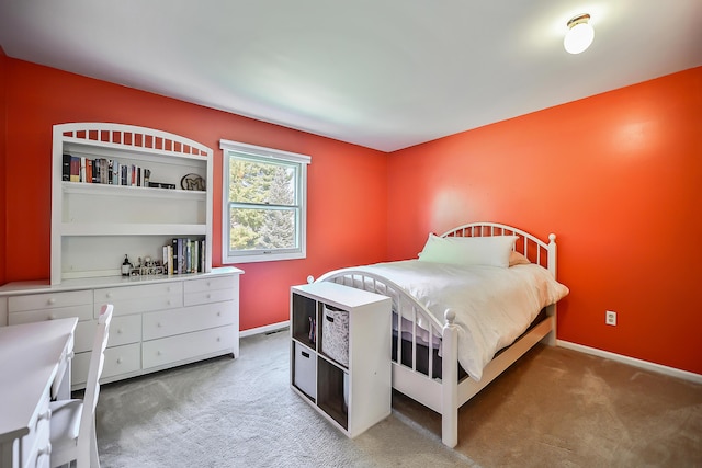 bedroom featuring baseboards and light colored carpet