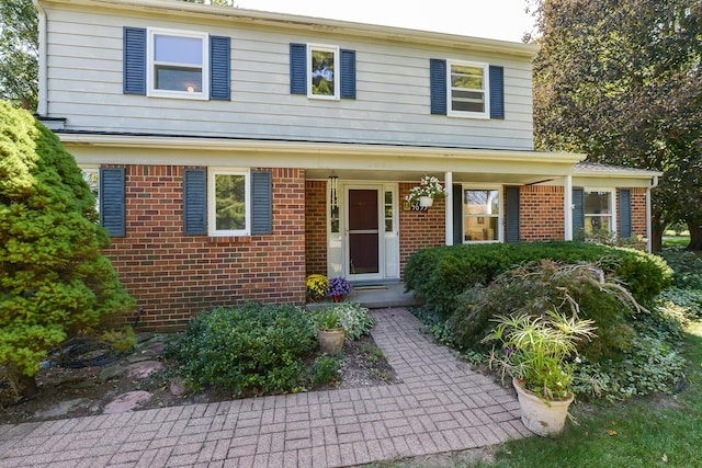 view of front of property featuring a porch and brick siding