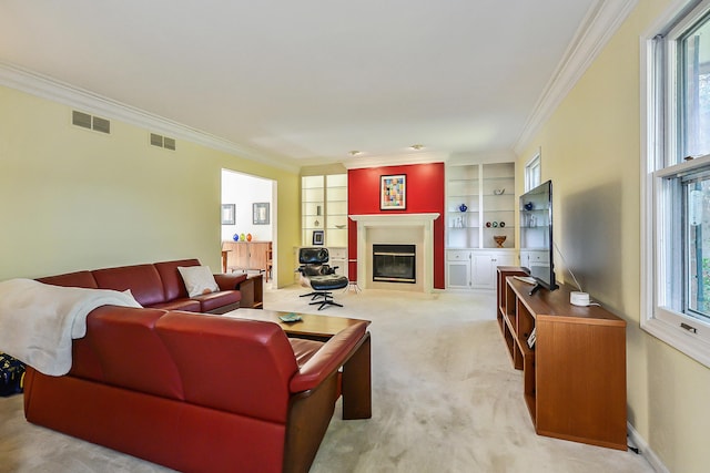 living area with visible vents, a fireplace with flush hearth, and crown molding