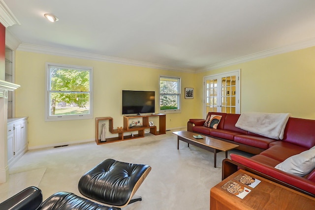 carpeted living area featuring crown molding, visible vents, baseboards, and plenty of natural light