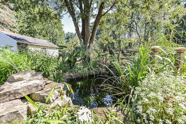 exterior space featuring a garden pond