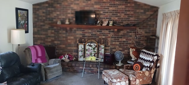 living area featuring carpet flooring and brick wall
