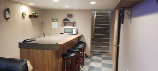 bar featuring tile patterned floors, recessed lighting, stairs, and a dry bar