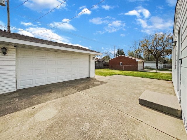 detached garage featuring fence