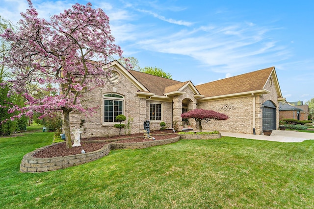 single story home featuring a garage, a front lawn, roof with shingles, and concrete driveway