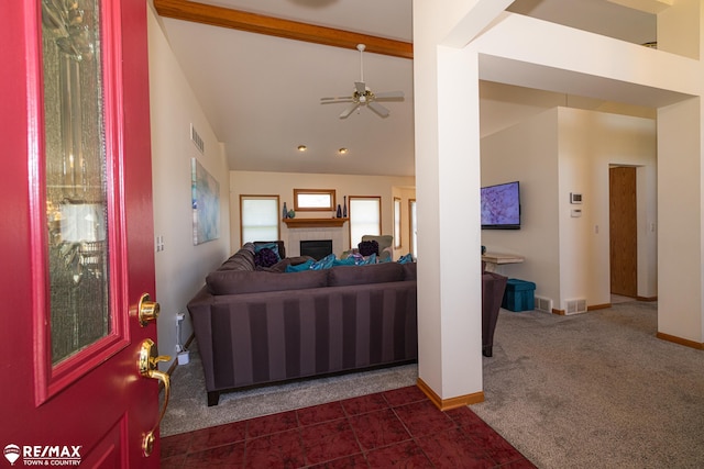 7077 Crosswinds Dr, Swartz Creek, MI 48473 - living area featuring a tiled fireplace, visible vents, vaulted ceiling with beams, and dark carpet