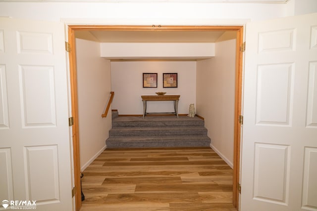 7077 Crosswinds Dr, Swartz Creek, MI 48473 - hallway with stairs, light wood-style flooring, and baseboards
