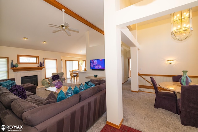 7077 Crosswinds Dr, Swartz Creek, MI 48473 - carpeted living room featuring a tile fireplace, high vaulted ceiling, beamed ceiling, and ceiling fan with notable chandelier