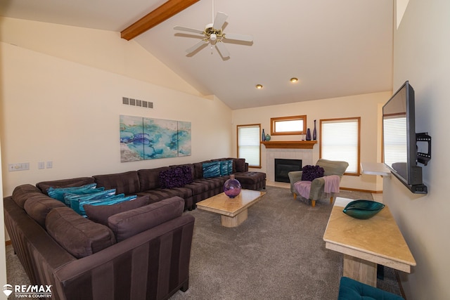 7077 Crosswinds Dr, Swartz Creek, MI 48473 - carpeted living room featuring beamed ceiling, visible vents, ceiling fan, a tile fireplace, and high vaulted ceiling