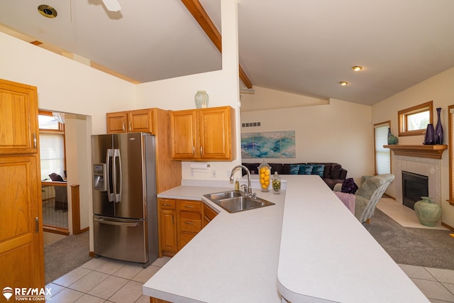 7077 Crosswinds Dr, Swartz Creek, MI 48473 - kitchen featuring stainless steel refrigerator with ice dispenser, a peninsula, light tile patterned floors, and a sink