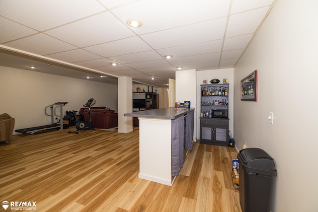 7077 Crosswinds Dr, Swartz Creek, MI 48473 - kitchen with dark countertops, light wood finished floors, black microwave, a peninsula, and open floor plan