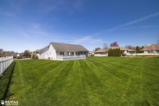 7077 Crosswinds Dr, Swartz Creek, MI 48473 - rear view of property featuring a lawn and fence