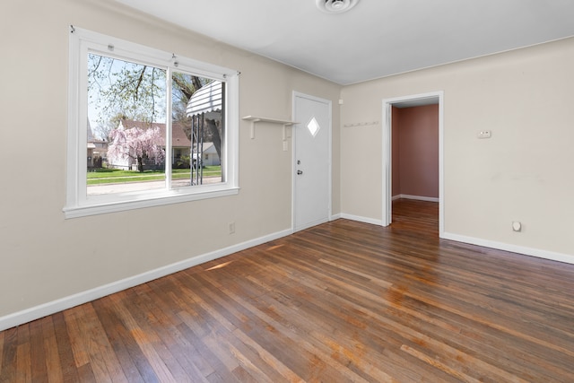 interior space with wood finished floors and baseboards