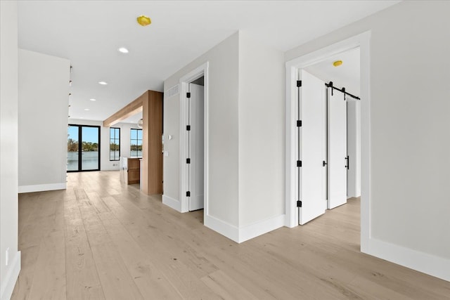 13459 Haddon St, Fenton, MI 48430 - corridor with recessed lighting, baseboards, a water view, and light wood-style floors