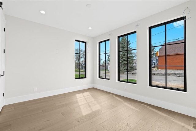 13459 Haddon St, Fenton, MI 48430 - unfurnished room with baseboards, recessed lighting, light wood-style flooring, and a wealth of natural light