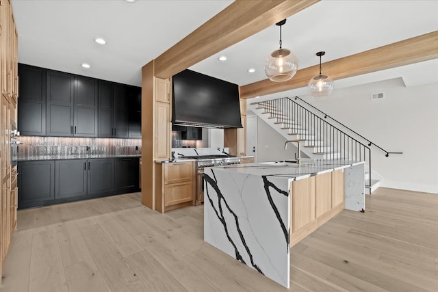 13459 Haddon St, Fenton, MI 48430 - kitchen with visible vents, light stone counters, a sink, appliances with stainless steel finishes, and exhaust hood