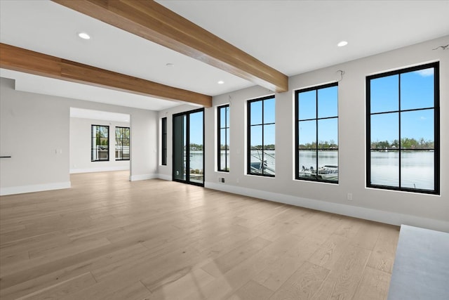 13459 Haddon St, Fenton, MI 48430 - unfurnished living room featuring beam ceiling, light wood finished floors, recessed lighting, baseboards, and a water view