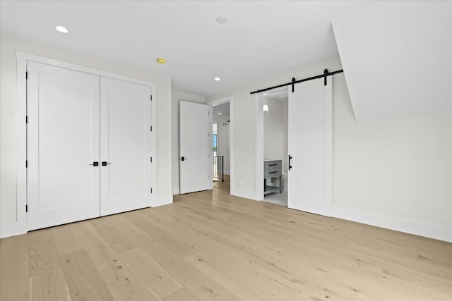 13459 Haddon St, Fenton, MI 48430 - unfurnished bedroom featuring baseboards, a barn door, light wood-style flooring, and recessed lighting