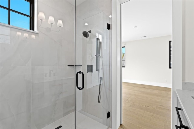 13459 Haddon St, Fenton, MI 48430 - full bathroom with a healthy amount of sunlight, a marble finish shower, and wood finished floors