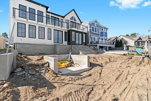 13459 Haddon St, Fenton, MI 48430 - view of side of property featuring stucco siding, a balcony, and a residential view