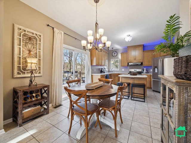 dining room featuring light tile patterned flooring and a notable chandelier