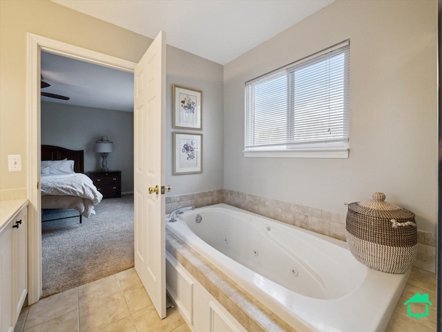 ensuite bathroom with a jetted tub, tile patterned floors, and ensuite bathroom
