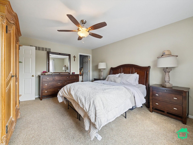 bedroom featuring baseboards, visible vents, a ceiling fan, and light colored carpet