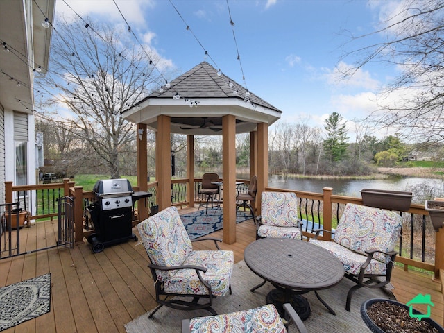 wooden terrace featuring a gazebo, area for grilling, outdoor dining area, and a water view