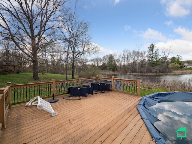 deck featuring a yard and a water view
