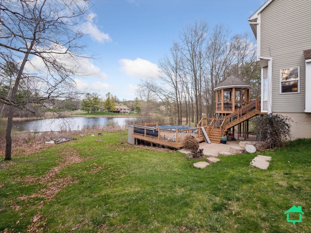 view of yard with a deck with water view