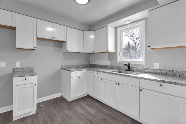 8790 E Outer Dr, Detroit, MI 48213 - kitchen featuring white cabinets, light stone counters, and a sink