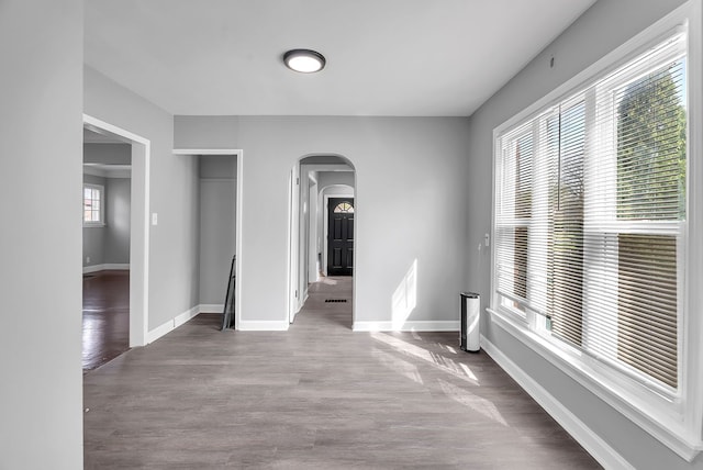 8790 E Outer Dr, Detroit, MI 48213 - interior space with arched walkways, wood finished floors, and baseboards