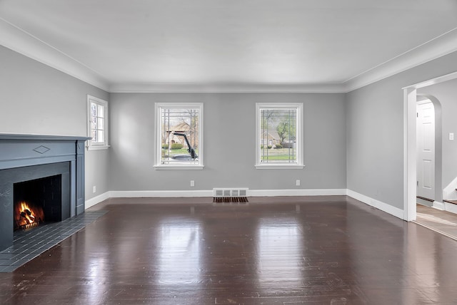 8790 E Outer Dr, Detroit, MI 48213 - unfurnished living room featuring wood finished floors, ornamental molding, baseboards, visible vents, and a fireplace with flush hearth