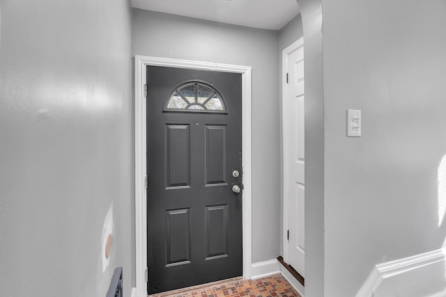 8790 E Outer Dr, Detroit, MI 48213 - entryway featuring baseboards, arched walkways, and brick patterned floor
